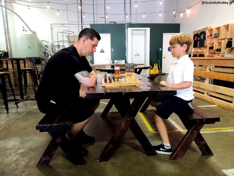 Jake McCluskey takes on a challenger in chess at the Strike Brewing Company warehouse taproom in San Jose
