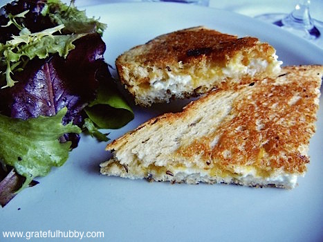 Goat cheese grilled cheese sandwich with apricot jam on rye bread