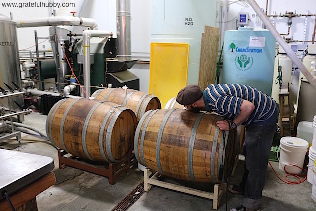 Strike brewer Tyler Rusten with 1 of the 4 recently filled barrels